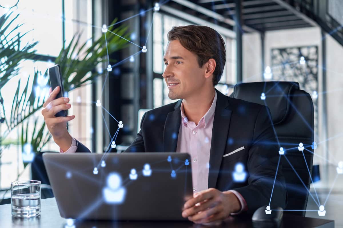 property manager man smiling while starting a computer accessing grace hill's intelligence+
