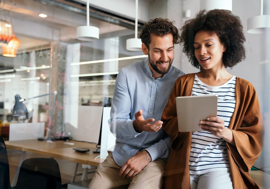 Successful group of employees, business people at work in corporate office taking an employee survey.