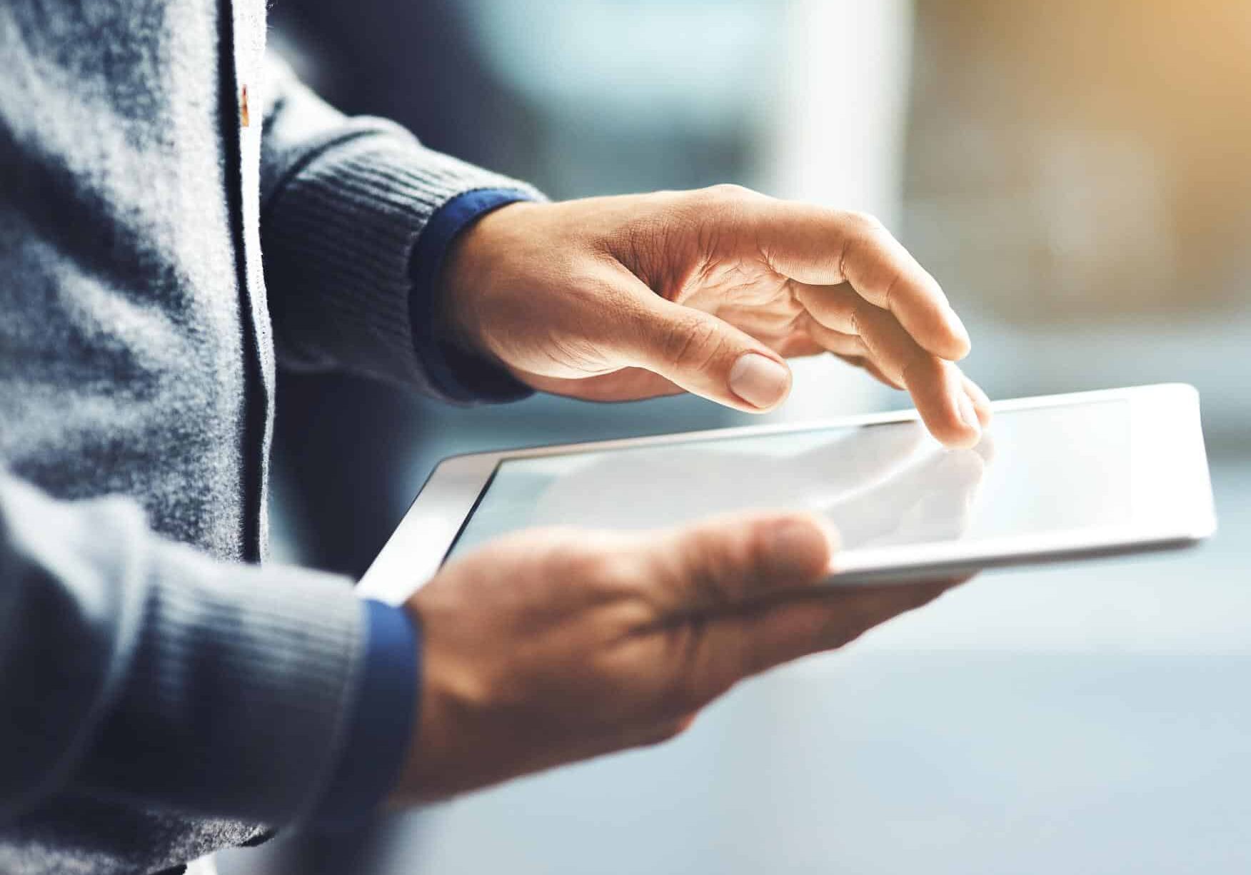 Closeup shot of an unrecognisable businessman using a digital tablet in an office
869617098