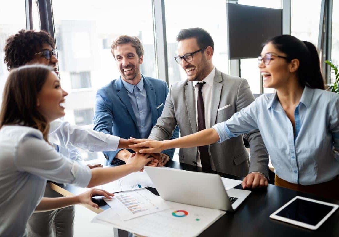 Property management team celebrating a good job in the office