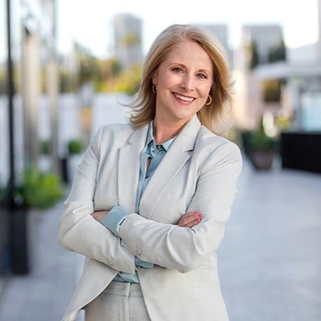 Headshot of attractive middle aged woman who is a training and development professional