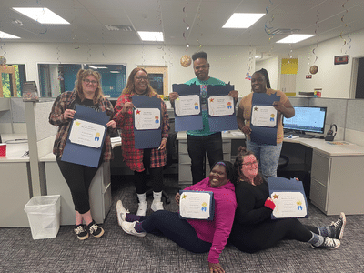 Grace Hill team members holding up awards.